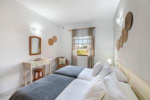 a bedroom with a bed and a desk and a window at Viento de Sal in Mazo +22 photos