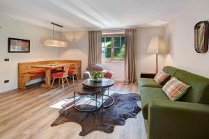 a living room with a couch and a table at Chalet Sonne - Livigno in Livigno