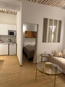 a living room with a couch and a table at Très Grand studio neuf 50 m du port Lovely charrons 2 in Saint-Tropez