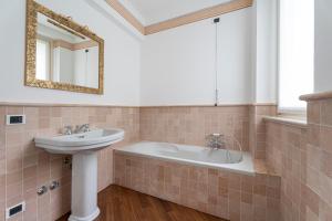a bathroom with a sink and a bath tub at Aa Apartments La Gioconda in Salò +28 photos