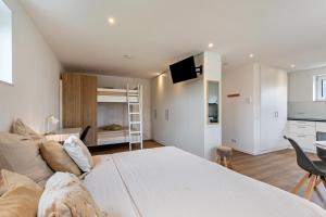 a living room with a large bed and a kitchen at Fewo Parkside S4 - 8Min Legoland in Günzburg