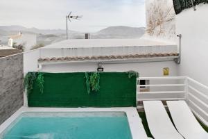 a swimming pool on the side of a building at Villa Españolillas in Olvera