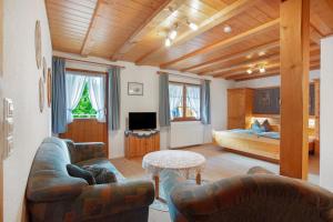 a living room with a couch and a bed at Gästehaus Klingele in Todtmoos