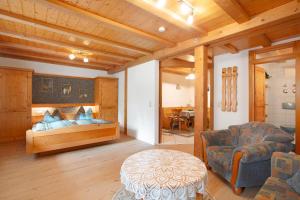 a bedroom with a bed and a chair and a table at Gästehaus Klingele in Todtmoos