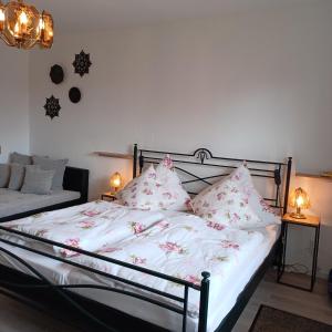 a bedroom with a bed with pink flowers on it at Ferienhaus Hahnenklee in Goslar