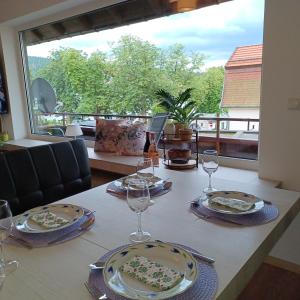 a table with wine glasses and a cake on it at Ferienhaus Hahnenklee in Goslar