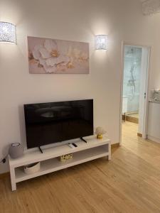 a living room with a large flat screen tv at Très Grand studio neuf 50 m du port Lovely charrons 2 in Saint-Tropez +25 photos