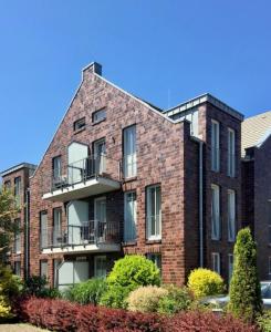 a brick building with balconies on the side of it at Ferienhaus Jümmers - Pidder in Horumersiel
