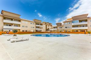 a courtyard with a swimming pool in front of a building at La Octava Isla in Puertito de Güímar