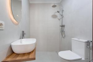 a bathroom with a white sink and a toilet at Luxury Ático Plaza in Playa de San Juan +22 photos