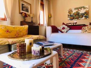 a living room with a couch and a table with candles at Kina House in Marsala
