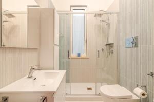 a bathroom with a sink and a toilet and a shower at Kina House in Marsala +20 photos