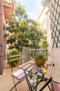a wooden table and chairs on a patio at Kina House in Marsala