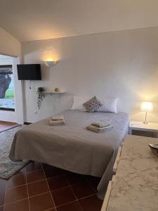 a bedroom with a bed with two towels on it at Casa Dade in Tavira