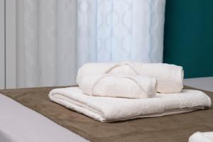 a stack of towels sitting on a table at Fantasia House in Marsala +48 photos
