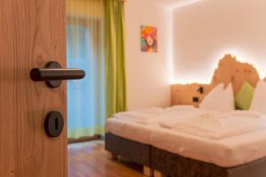 a bedroom with a bed with a wooden door at Dolomites Apartment Christian in Ortisei +34 photos