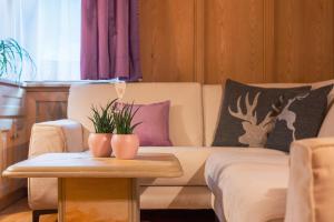 a living room with a couch and a table at Dolomites Apartment Christian in Ortisei