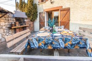 a table with plates of food on it on a patio at La ferme du château in Venon