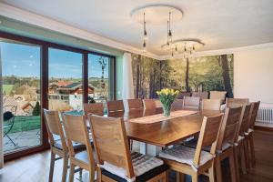 a dining room with a table and chairs at Freiraum in Weiler-Simmerberg +26 photos