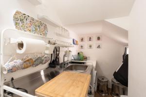 a small kitchen with a sink and a counter at Civico17 in Santa Ninfa