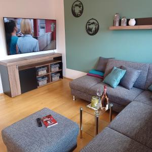 a living room with two couches and a flat screen tv at Ferienhaus Hahnenklee in Goslar