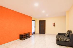 a living room with a couch and a table at Hotel O New Alipore in Kolkata