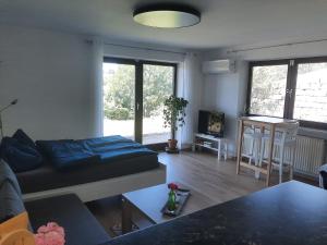 a living room with a bed and a couch at Am Dorfweiher in Tettnang