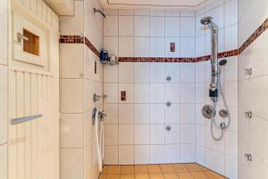 a bathroom with a shower with white tiles at Fewo Straub in Freudenstadt +19 photos