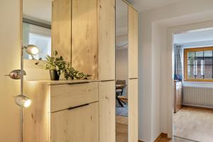 a room with a wooden cabinet with a plant on it at Fewo Straub in Freudenstadt