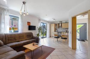 a living room and kitchen with a couch and a table at Ferienwohnung Walter in Ellenbach