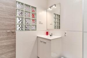 a white bathroom with a sink and a mirror at Nerja Boutique B3 Sweet Corner in Nerja +19 photos