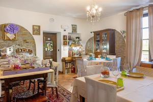 a restaurant with tables and chairs in a room at Locanda Casa Bardacchino in Mango