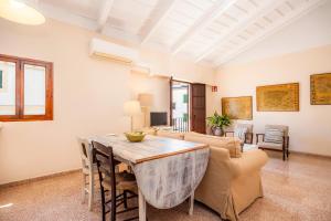 a living room with a table and a couch at Can Claret in Felanitx +15 photos