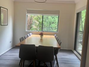 a dining room table with chairs and a window at The Castle in Castle Hill