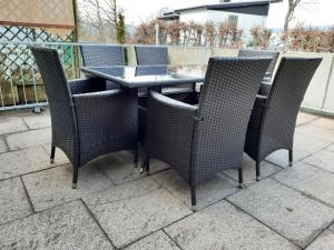 a patio table and chairs on a patio at Yachthof Ferienwohnung, 60 m² in Scheid