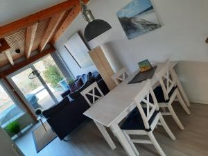 a dining room and living room with a table and chairs at Yachthof Ferienwohnung, 60 m² in Scheid