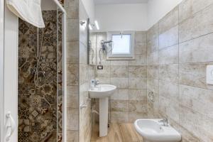 a bathroom with a sink and a shower at Dimore degli innamorati in Presicce +27 photos