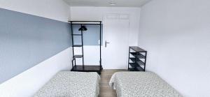 a room with two beds and a door in it at Büsummchen in Büsum +5 photos
