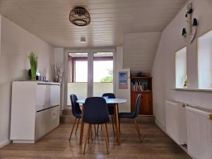 a kitchen and dining room with a table and chairs at Büsummchen in Büsum