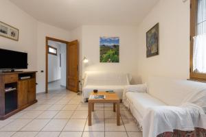 a living room with a couch and a table at Casa Colonia 1 in SantʼAnna Arresi