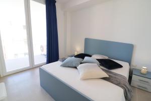 a bedroom with a large bed with pillows on it at Holiday home Galatea a Otranto in Otranto