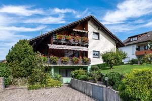 a house with flower boxes on the balcony at Haus Berger in Wehr