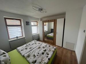 a bedroom with a bed and a mirror at Grünes Haus Dornburg in Dornburg