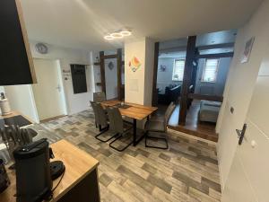 a living room with a dining room table and chairs at Grünes Haus Dornburg in Dornburg +6 photos