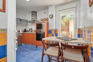 a kitchen with a table and chairs in it at Las Lomas de Marina del Este in Almuñécar