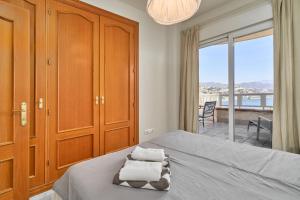 a bedroom with a bed with towels on it at Las Lomas de Marina del Este in Almuñécar +26 photos
