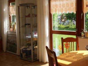 a dining room with a table and a window at Haus Sonnengarten in Seelbach