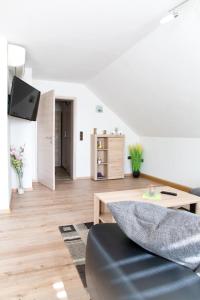 a living room with a couch and a table at Ferienwohnung Am Palmengarten in Marktbergel