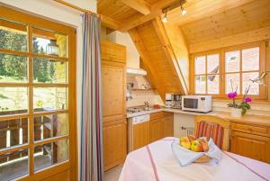 a kitchen with a table with a bowl of fruit on it at Ferienhaus Esche in Hinterzarten