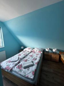 a bedroom with a bed with two pillows on it at Nocowanie w młynie in Niedzica